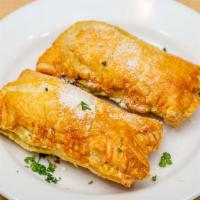 Spanakopita  · 2 Puff pastries filled with spinach and feta cheese.