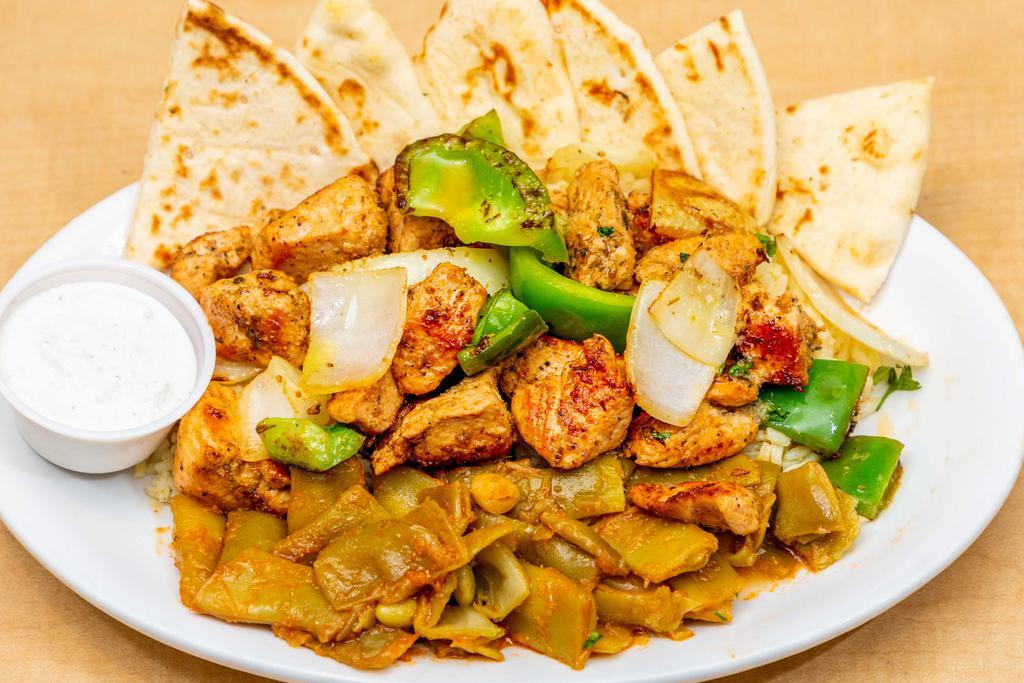 Chicken Souvlaki* · Cubes of chicken breast marinated in a lemon-garlic and herb sauce served with onions and green peppers on a bed of rice.