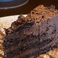 Chocolate Cake · Chocolate layer  cake filled with a rich chocolate cream, topped with a chocolate miroir.