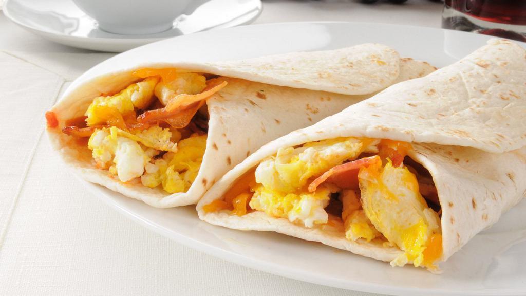 Big Bacon Breakfast Burrito · Two fluffy scrambled eggs, melty shredded Cheddar cheese, crispy, smoky bacon and skillet browned breakfast potatoes wrapped in a large, soft, flour tortilla.