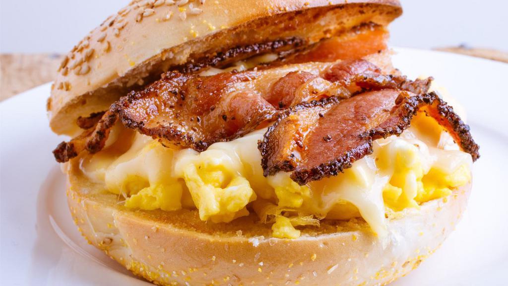 Eggs, Cheese & Bacon Brioche Sandwich · Fluffy, scrambled eggs layered with crispy, smoky bacon and melty Cheddar cheese on a soft, buttery, toasted brioche roll.