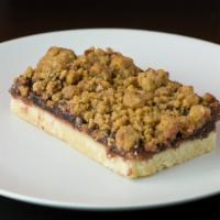 Raspberry Bar · House-made shortbread crust topped with raspberry jelly and a crumb topping.