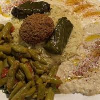 Sampler Plate · A sample of our hummus, garlic dip, baba-ghanouj, syrian green bean salad, grape leaf, falaf...