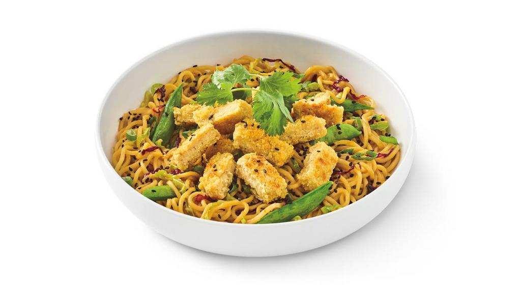 Impossible™ Orange Chicken Lo Mein · Lo mein noodles sautéed in orange sauce with. snap peas, napa and red cabbage, then topped with. impossible™ Panko Chicken Made From Plants,. green onions, black sesame seeds and cilantro..