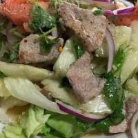 Beef Salad · Grilled sirloin with cucumbers, tomatoes, onions, lettuce tossed in a spicy lime dressing.