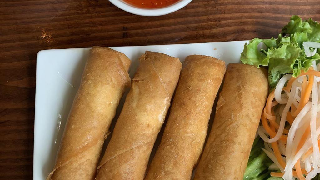 Crispy Spring Rolls · Vegan. Fried rolls with onions, taro root, carrots, cabbage, mung beans, and tofu. Includes sweet chili sauce.