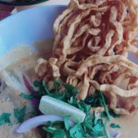 Khao Soi Gai · Northern styles curry noodle. slow cooking chicken drumstick topped with crispy noodle, lime...