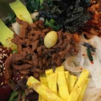 Hot Stone Bibim-Bap · It is served as bowl of warm rice topped with vegetables, fried egg in hot sizzling stone po...