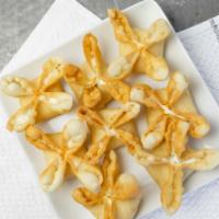 Fried Cheese Wontons (8) · Delicious creme cheese with bits of chopped carrot & green onion inside a golden crisp wonto...