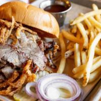 Brisket · hickory smoked, sliced thing with a tangy Memphis BBQ sauce topped with fried onion strings ...