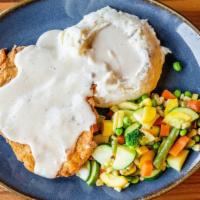 Chicken Fried Chicken · Tenderized boneless chicken breast, lightly breaded and golden fried, mashed potatoes, crack...