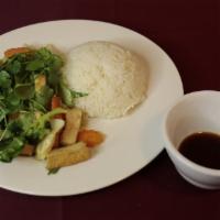Tofu And Rice · Vegan. Stir fried tofu onion broccoli served on a bed of rice.