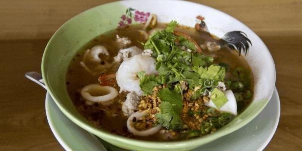 Kuay Teaw Tom Yum · (Hot and Sour Noodle Soup)This main course soup features rice noodles with shrimp, squid, BBQ Pork, and minced pork in a spicy broth with bean sprouts, onions and ground peanuts.