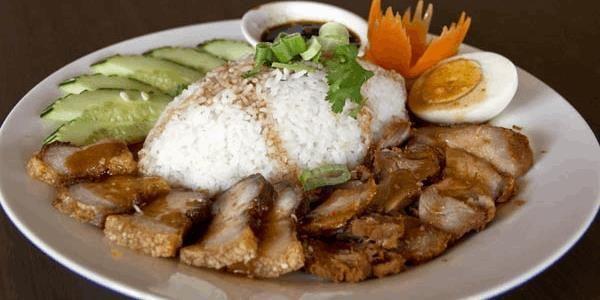 Khao Moo Dang · (BBQ Pork & Crispy Pork)  Sliced marinated BBQ pork and crispy pork over rice with Thai BBQ sauce.