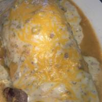 Breakfast Burrito · Scrambled eggs, hash browns and cheese wrapped in a fresh made tortilla. Smothered with a po...