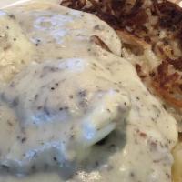 Country Benedict · 2 Eggs prepared your way, sausage patty on a grilled biscuit topped with sausage gravy and c...