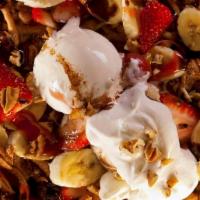 Banana Split Funnel Cake · Funnel cake topped with banana, ice cream scoop, whipped cream, caramel, and strawberry sauce.