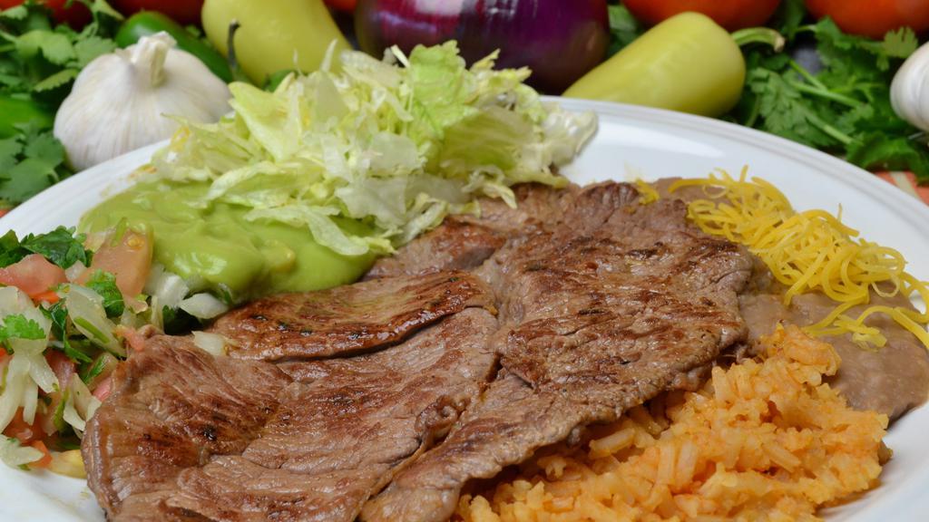 #15. Carne Asada Plate · Two slabs of steak, Pico and Guacamole, comes with Rice, Beans and Cheese