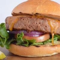 Vegan All American Burger · Beyond burger patty on a flatbread bun. Vegan cheddar, tomato, red onion, lettuce and pickles.