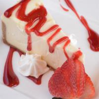 House Cheesecake · Slice of classic cheesecake with raspberry sauce.