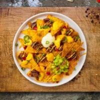 Nacho Zilla Chorizo Fries  · Chorizo, mozzarella, chipotle, cilantro, ground beef, grilled onions topped on Idaho potato ...