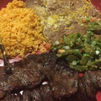 Carne Asada (8 Oz) · Tender steak char broil to perfection. Served with grilled green onion and a deep-fried jala...