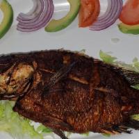 Whole Fried Fish Tilapia Dorada · Marinated deep-fried tilapia prepared in a garlic sauce. Served with rice, beans, and tortil...