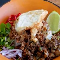 Sisig · Crispy pork belly and pig head sauteed with garlic, onions and jalapeños. Served over rice a...