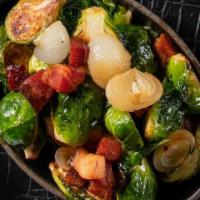 Crispy Brussels Sprouts · Fried brussels sprouts, shallots & bacon tossed in an apple cider glaze.