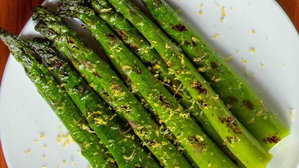 Asparagus · Grilled asparagus with lemon, olive oil & topped with lemon zest.
