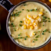 Sweet Corn Pudding · Creamy corn in a sweet & fluffy custard. Topped with chives.