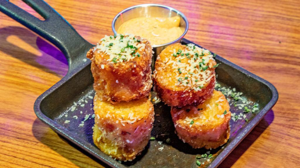 Tater Tots · Crispy tater tots filled with Cheddar, Jack, Parmesan & fontal cheese's. Fried, seasoned & topped with chives. Spicy remoulade sauce served on the side.