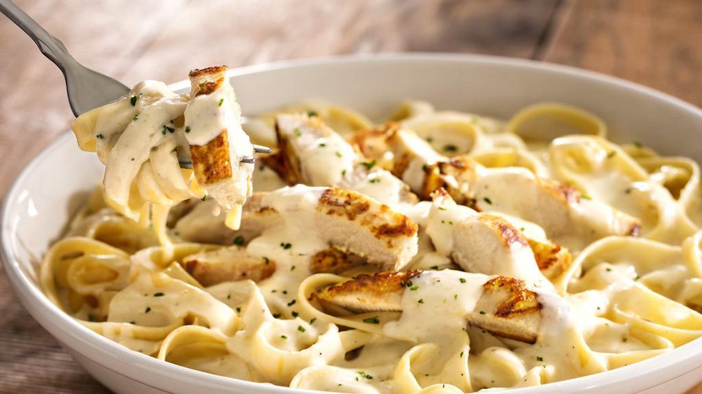 Chicken Fettuccine Alfredo  · A traditional creamy favorite with chicken, Parmesan and Romano cheeses tossed in fettuccini pasta. Comes with bread. Tax included.