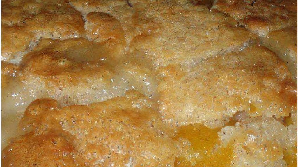 Peach Cobbler (Slice) · Ripe sweet peaches are the heart of this dessert, built on a foundation of natural sweetness with a batter that’s delicious, buttery and full of southern goodness.