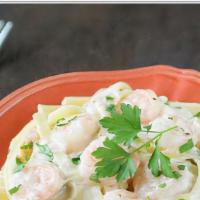 Shrimp Fettuccine Alfredo  · A traditional creamy favorite with chicken, parmesan and Romano cheeses tossed in fettuccini...