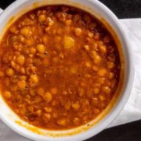 Lentil Soup · Vegan. Lentil soup mixed with finely chopped onions and flavored with turmeric and cumin spi...