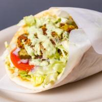 Falafel Pita · Vegan. Chickpea & fava beans ground with vegetables and spices served in a pita bread with l...