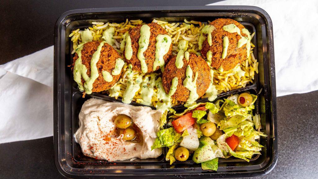 Falafel Bowl (Vegan) · Two falafels (chickpea & fava beans ground with vegetables and spices), with seasoned rice, Mediterranean Salad, and your choice of hummus, spicy hummus, or baba ghanouj.