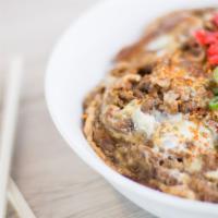 Gyudon · Thinly sliced beef in dashi mirin sauce with sautéed onions, served with eggs and over white...