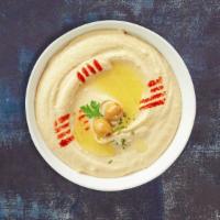 Hummusaria · Cooked and mashed chickpeas blended with tahini, lemon juice, and garlic.