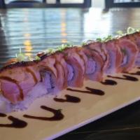Lion King Roll · California roll, seared salmon with parmesan aioli, unagi sauce topped with scallions