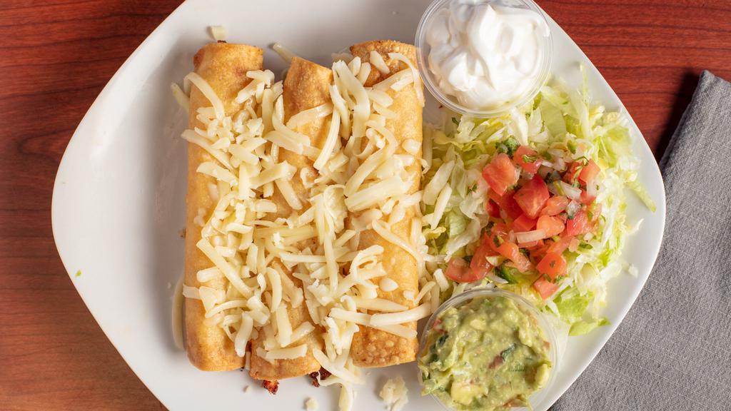 Three Rolled Tacos Plate · Includes rice, beans, guacamole, cheese, sour cream, lettuce, and pico de gallo.