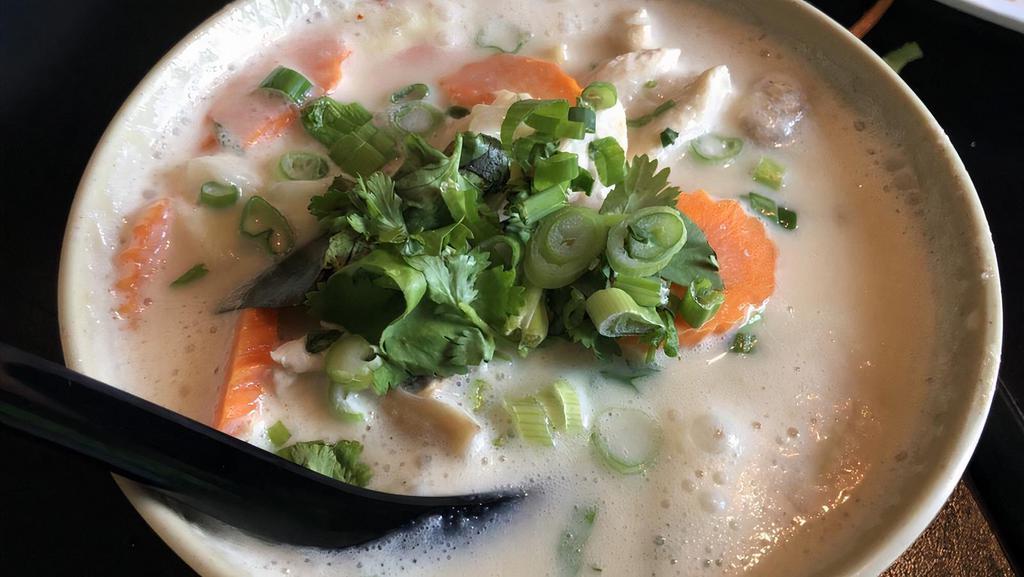 Chicken Coconut Milk Soup · A traditional creamy style hot and sour soup, chicken, coconut mil, mushroom, galangal, lemongrass, lime leaf, lime juice, fish sauce, chili, and cilantro.