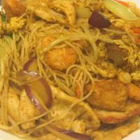 Singapore Curry Noodle · Thin rice noodles with veggies BBQ pork, chicken and shrimp in a yellow curry stir fry.