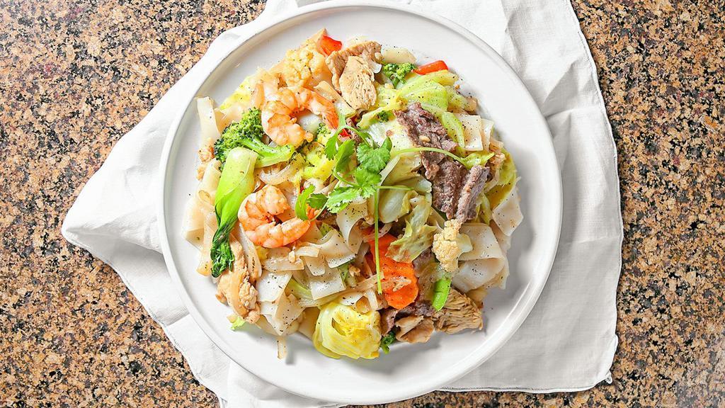 Pho Ap Chao (Soft Or Crunchy) · Stir fried rice noodle with shrimp, chicken, beef and vegetables.