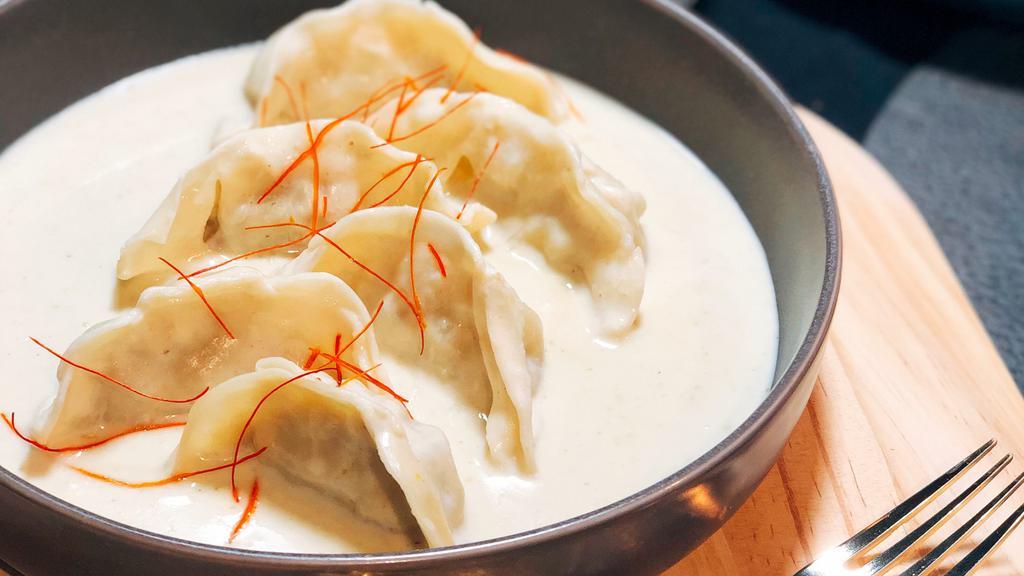 Curry Dumplings (6)  · Steamed pork and vegetable dumplings served with a green curry sauce.