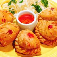 Thai Curry Puff With Chicken (5) · Fried puff pastry filled with yellow curry, diced chicken, potato and yam.