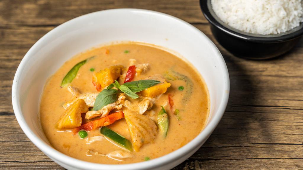 Pumpkin Curry · Pumpkin cooked in red curry with bell peppers, peas and Thai basil.