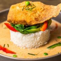 Salmon With Panang Curry · Salmon filet with panang curry sauce served with steamed baby bok choy, carrots, and bell pe...