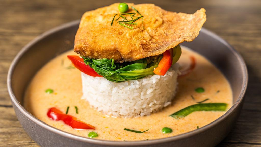 Salmon With Panang Curry · Salmon filet with panang curry sauce served with steamed baby bok choy, carrots, and bell peppers.